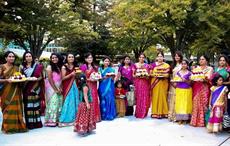 Women holding Bathukamma in their hands. Courtesy: Telangana government