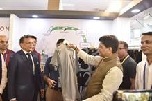 Textile minister Piyush Goyal examining a garment at IIGF. Pic: Twitter