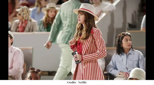 A person in a red and white striped dress and hatDescription automatically generated