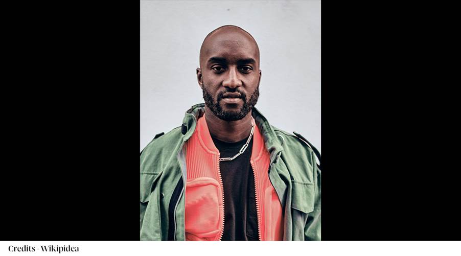 A person with a beard and a green jacket
Description automatically generated