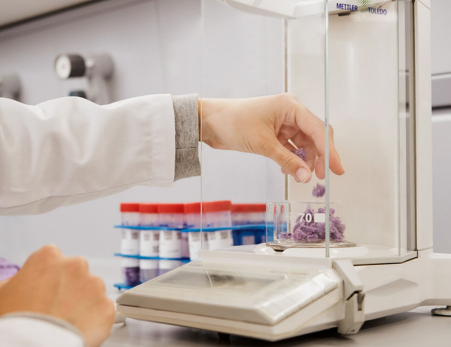 A person in a lab coat holding a container

AI-generated content may be incorrect.
