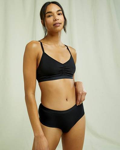 A person wearing a black bikiniDescription automatically generated with low confidence