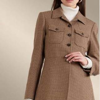 A person wearing a coatDescription automatically generated with medium confidence
