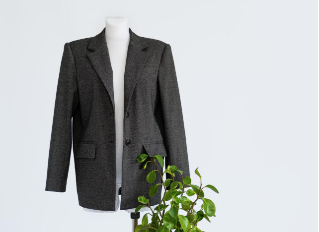 A picture containing suit, person, posingDescription automatically generated