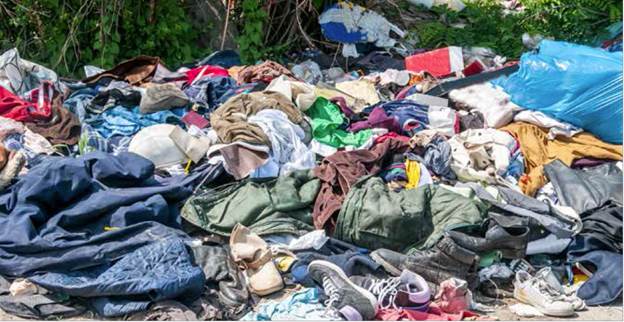 A person lying in a pile of garbage
Description automatically generated with low confidence