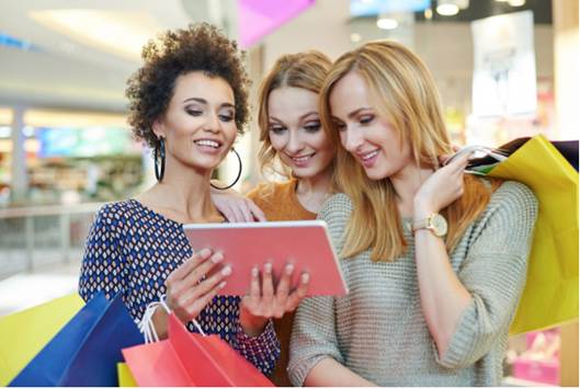 A group of women looking at a tablet
Description automatically generated with low confidence