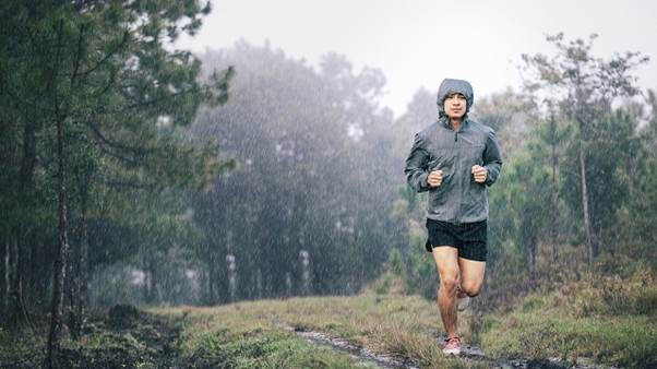 A person running on a trail in the woodsDescription automatically generated with low confidence