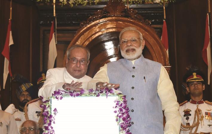 President Pranab Mukherjee and Prime Minister Narendra Modi pressing the buzzer to launch the Goods & Service Tax (GST), in Central Hall of Parliament, in New Delhi, in the midnight of June 30- July 0