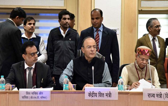 Union Minister for finance Arun Jaitley chairing the 25th GST Council meeting, flanked by minister of state for finance Shiv Pratap Shukla (right) and finance secretary Dr Hasmukh Adhia. Courtesy: PIB