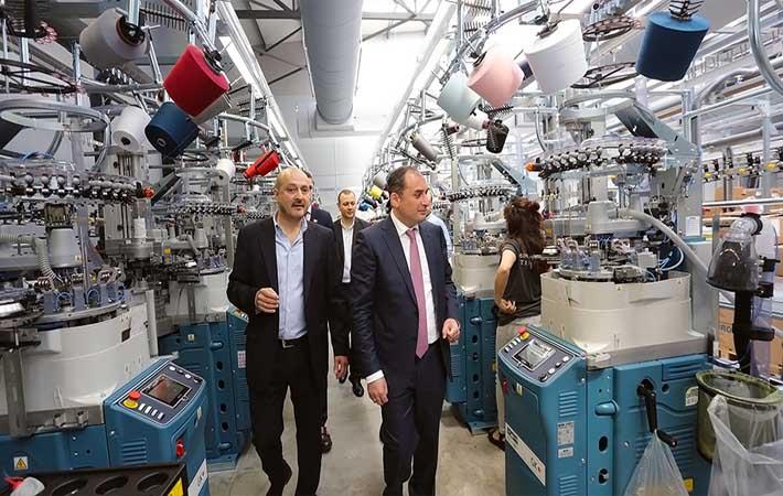 Dimitry Kumsishvili (wearing tie) and Mikheil Khidureli taking a tour of the new factory. Courtesy: Ministry of economy and sustainable development of Georgia
